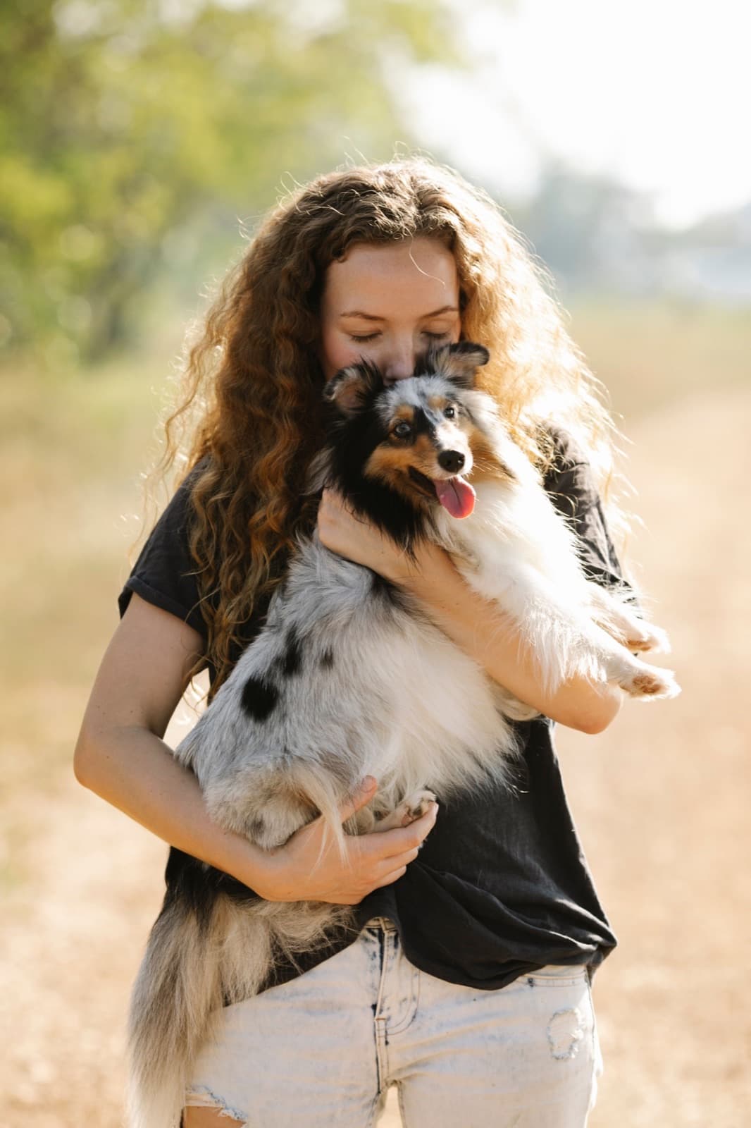 Keeper holding their dog outdoors – reuniting pets with their families